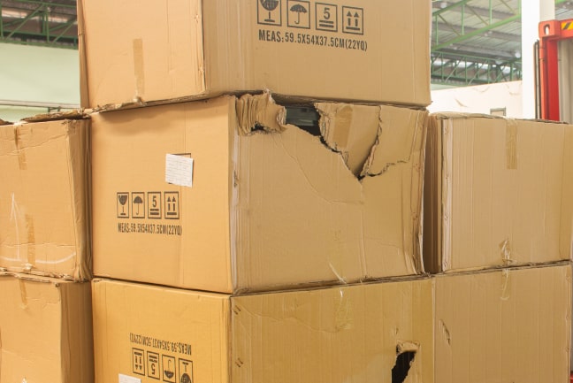 damaged box cartons unloading from trailer